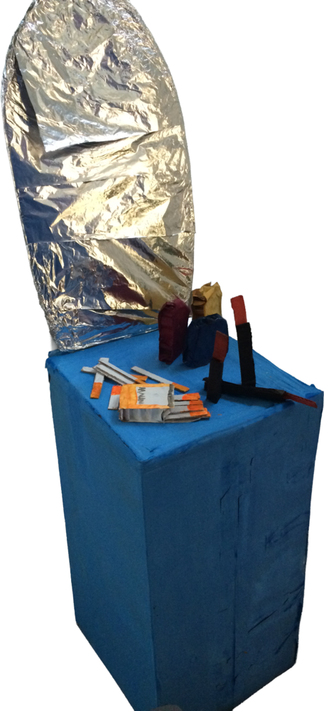 A handmade blue dressing table with a foil-covered mirror and small props.