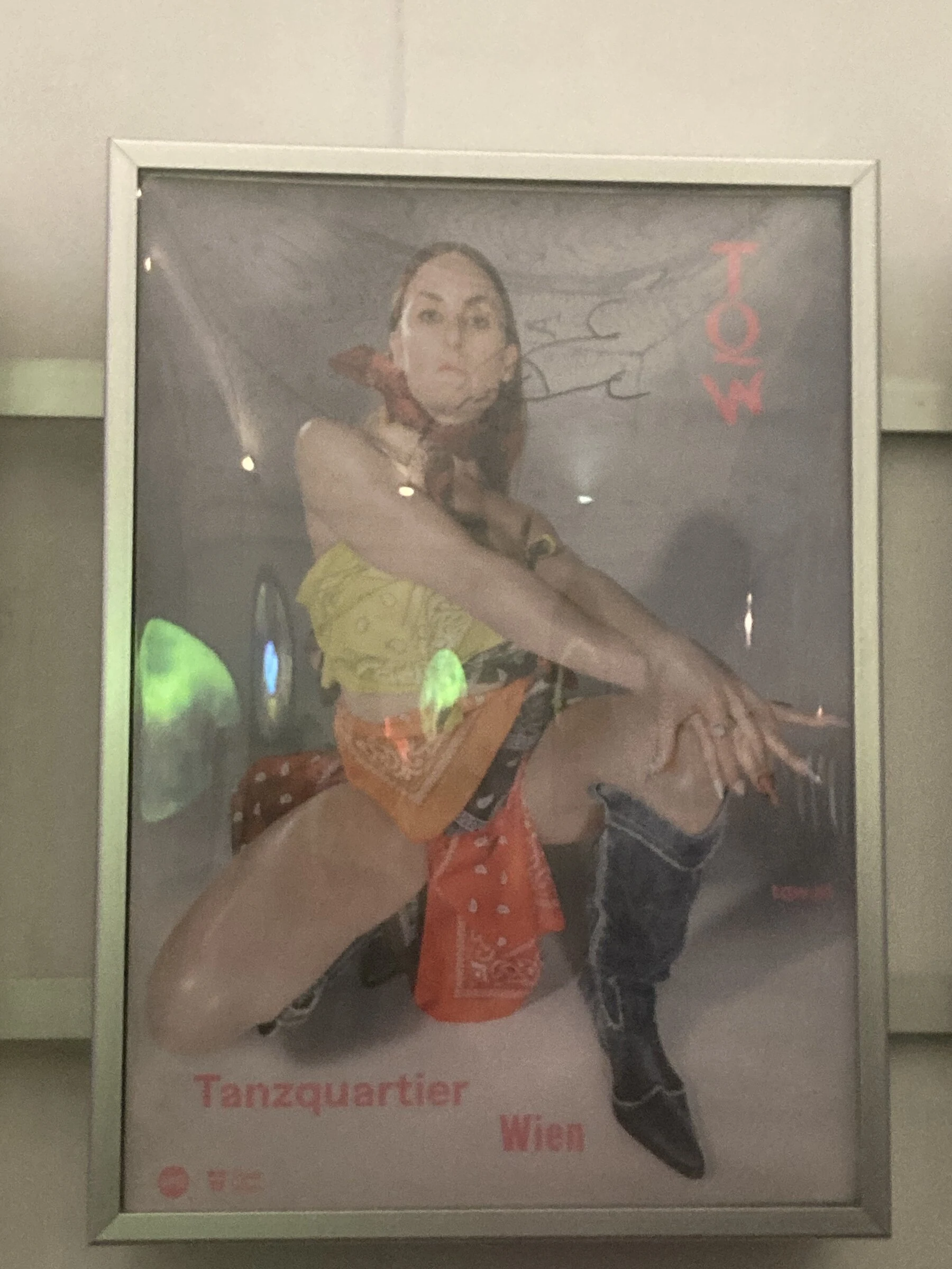 The Tanzquartier portrait poster displayed in a framed indoor advertising panel.
