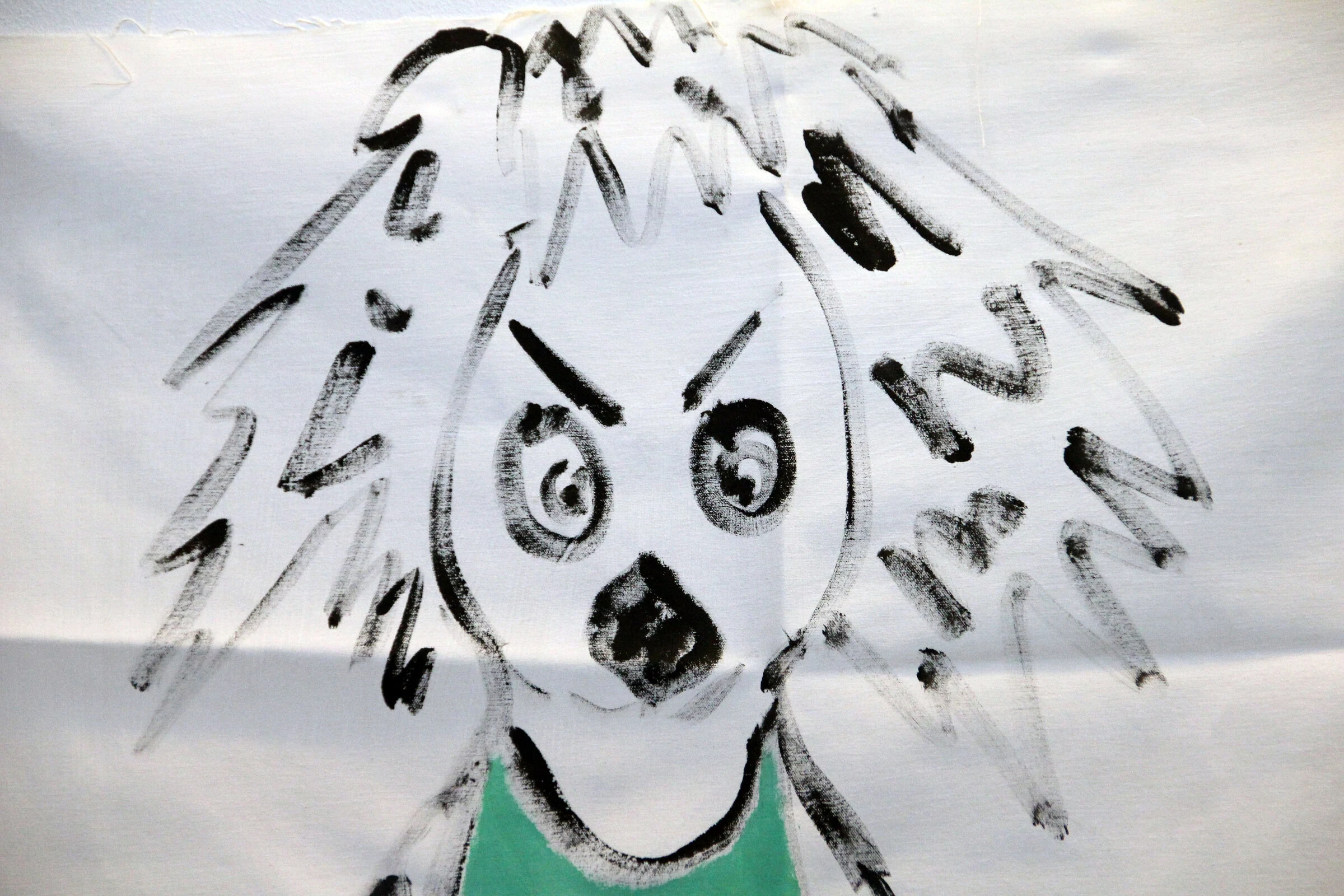 A close-up of the wild-haired painted figure on the scooter backdrop.