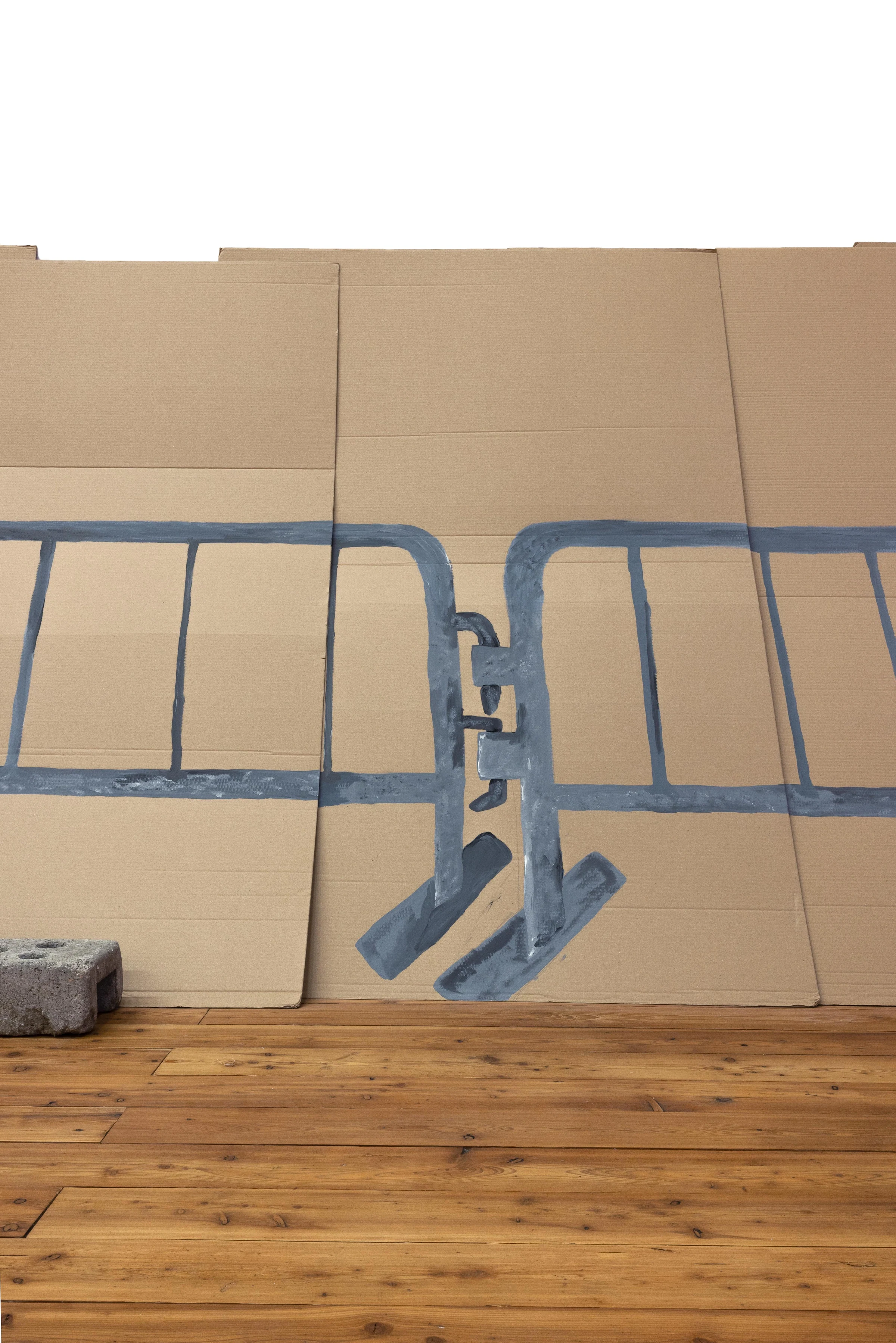 A close-up of two blue crowd-control barriers painted on cardboard panels.