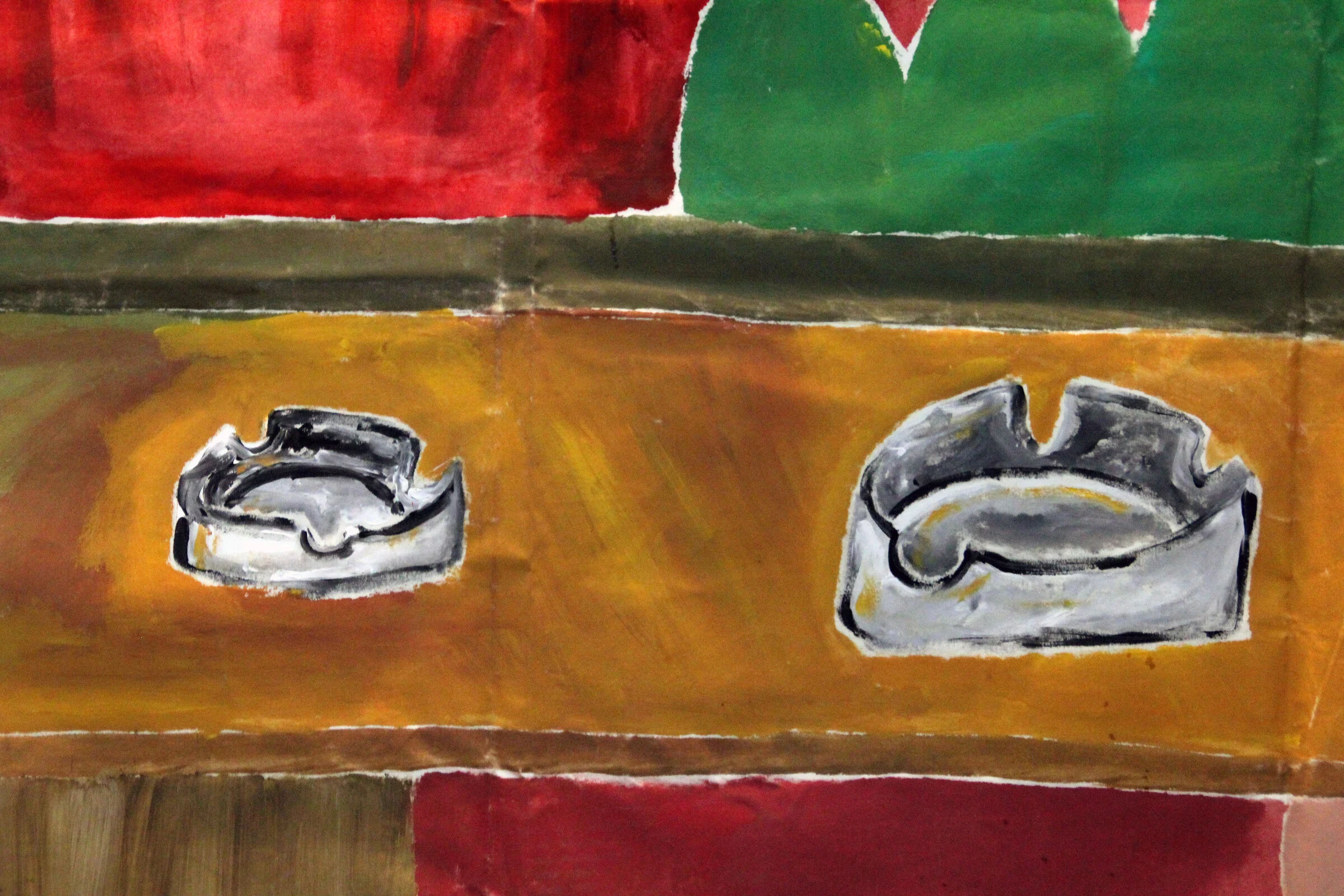 A detail of two grey ashtrays painted on the brown bar counter backdrop.