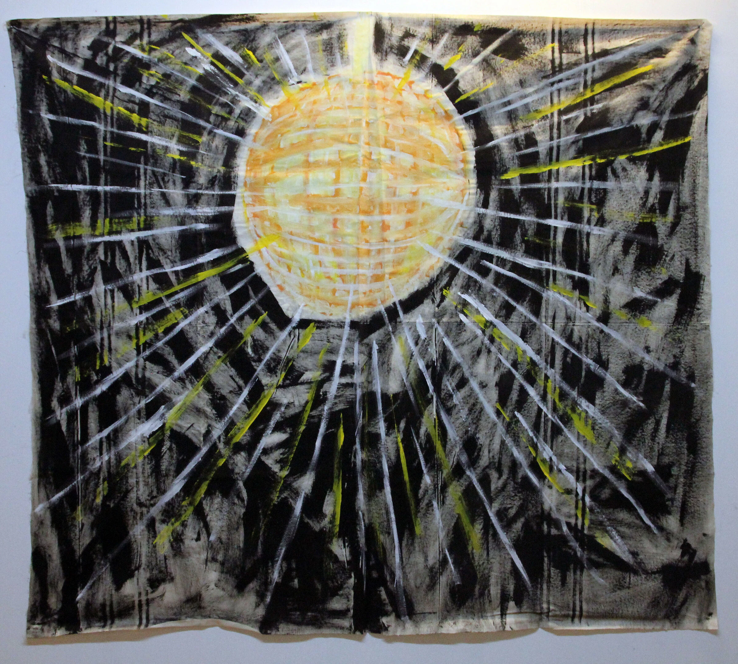 A black canvas backdrop with a glowing yellow disco ball and white and yellow rays.
