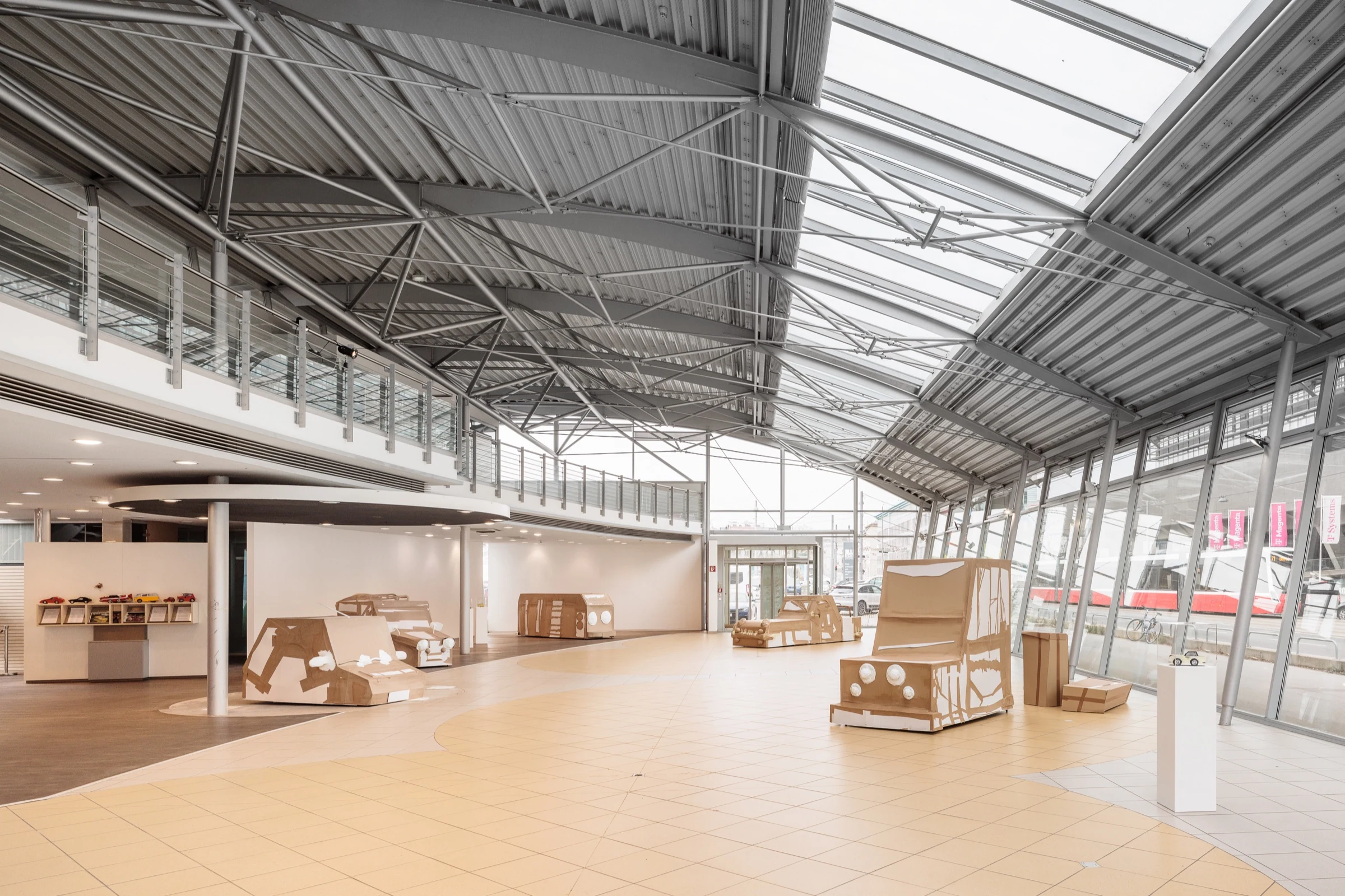 A wide view of the GASH STATION installation beneath the showroom glass roof.