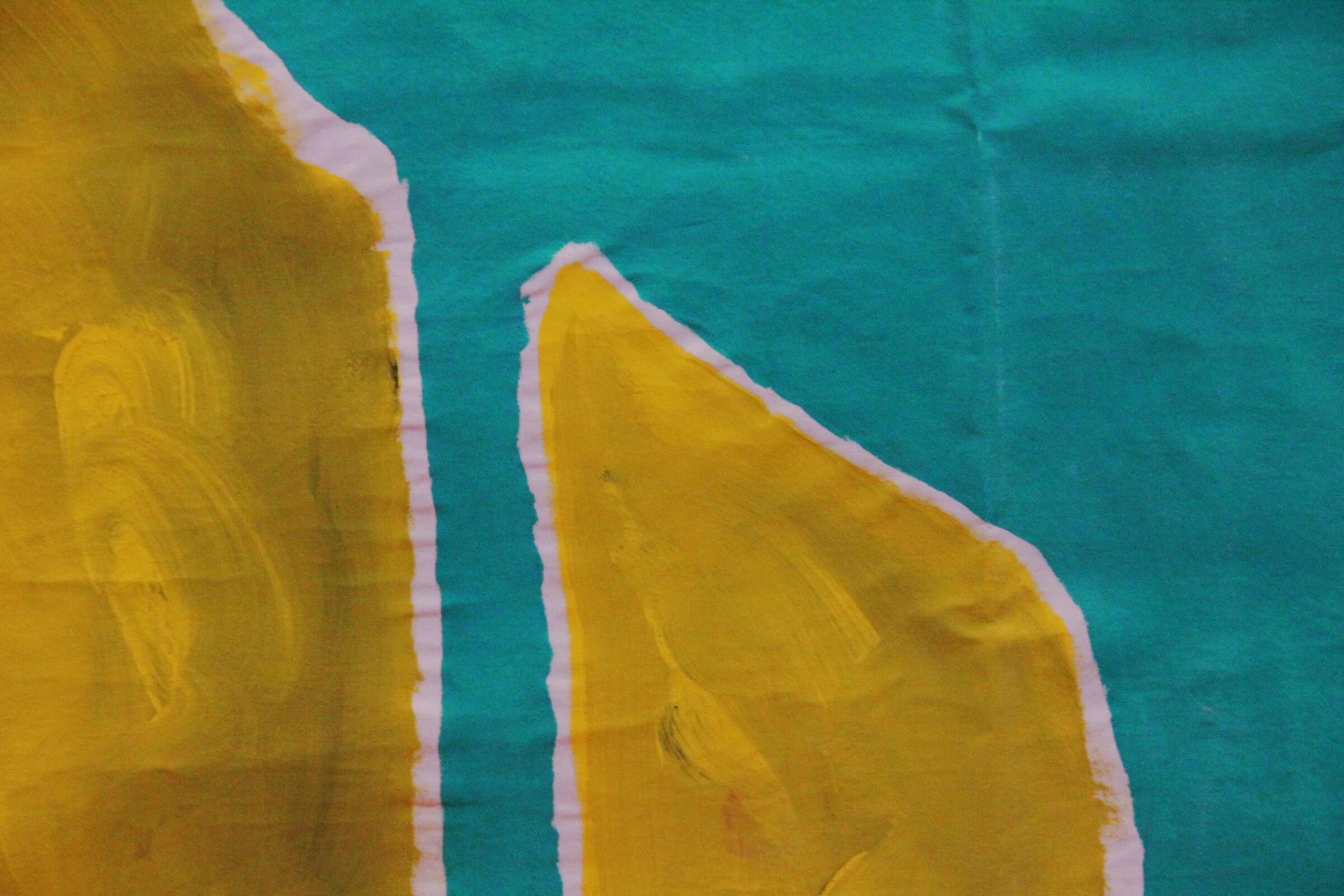 A detail of yellow triangular shapes against teal paint on canvas.