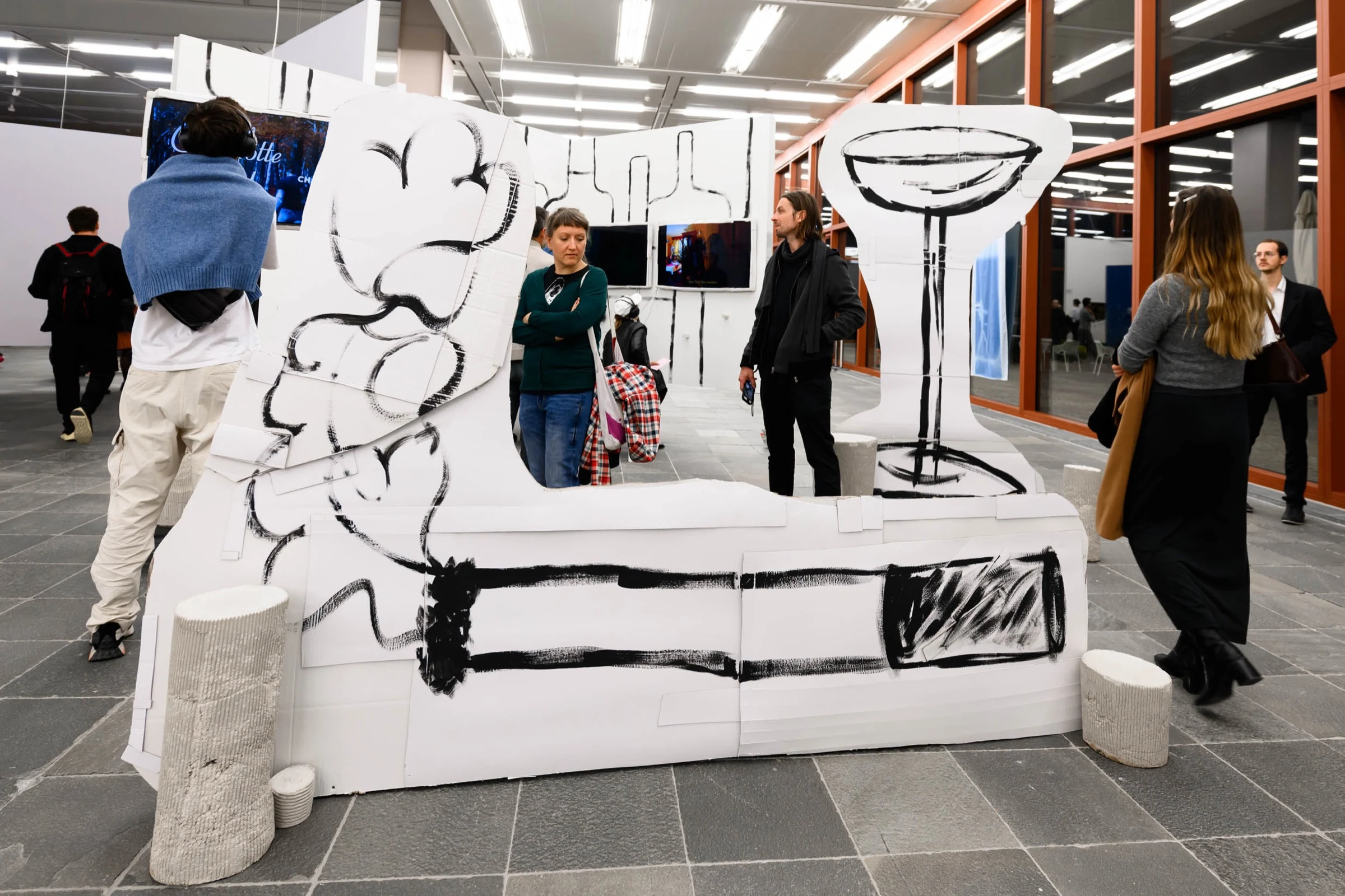 Visitors viewing the LOCATION installation at the exhibition opening.