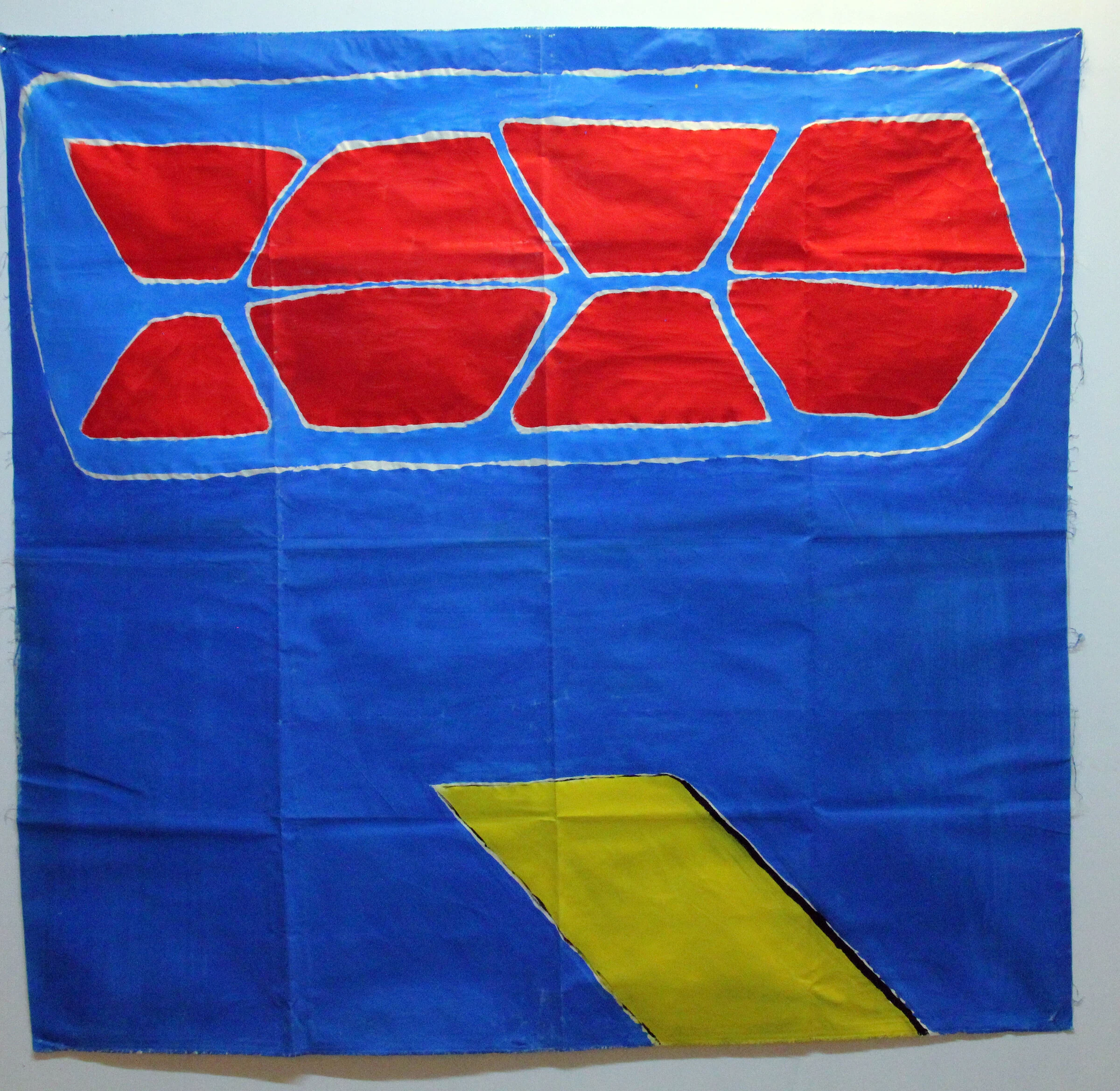 A blue canvas backdrop with red geometric shapes above a diagonal yellow strip.