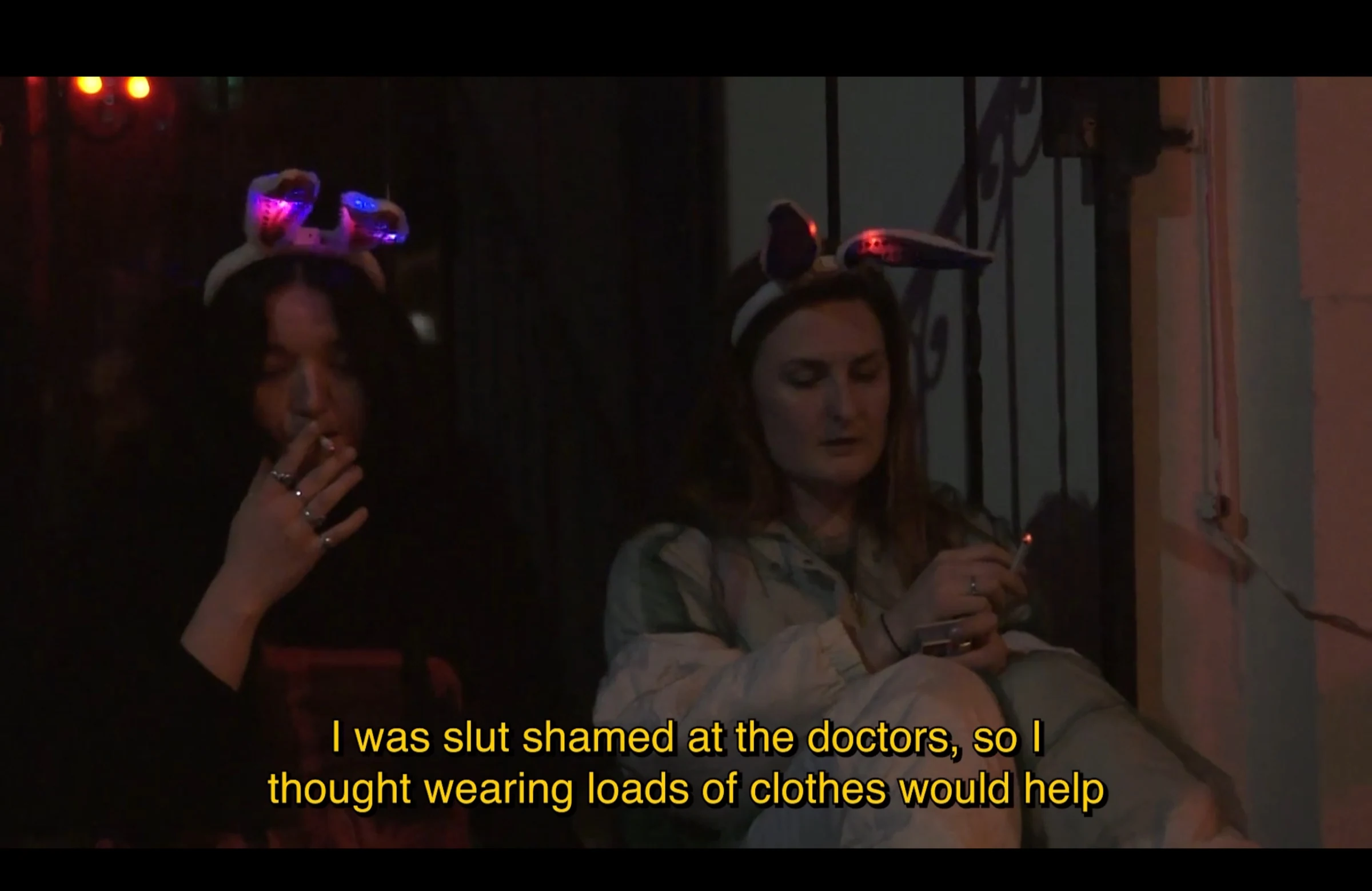 Two characters wearing bunny-ear headbands and smoking at a party.