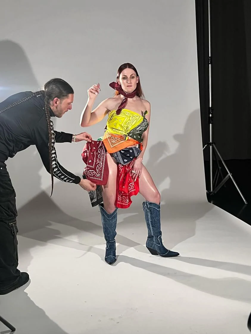 A stylist adjusting Charlotte's bandana outfit during the Tanzquartier studio photo shoot.