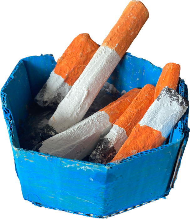 A handmade blue cardboard ashtray filled with sculpted cigarettes.