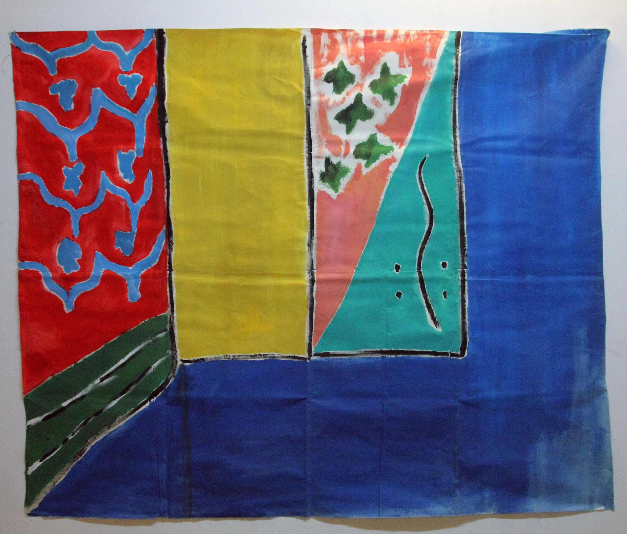 A painted interior backdrop with red and blue patterns, a yellow panel and green stars on pink and teal.
