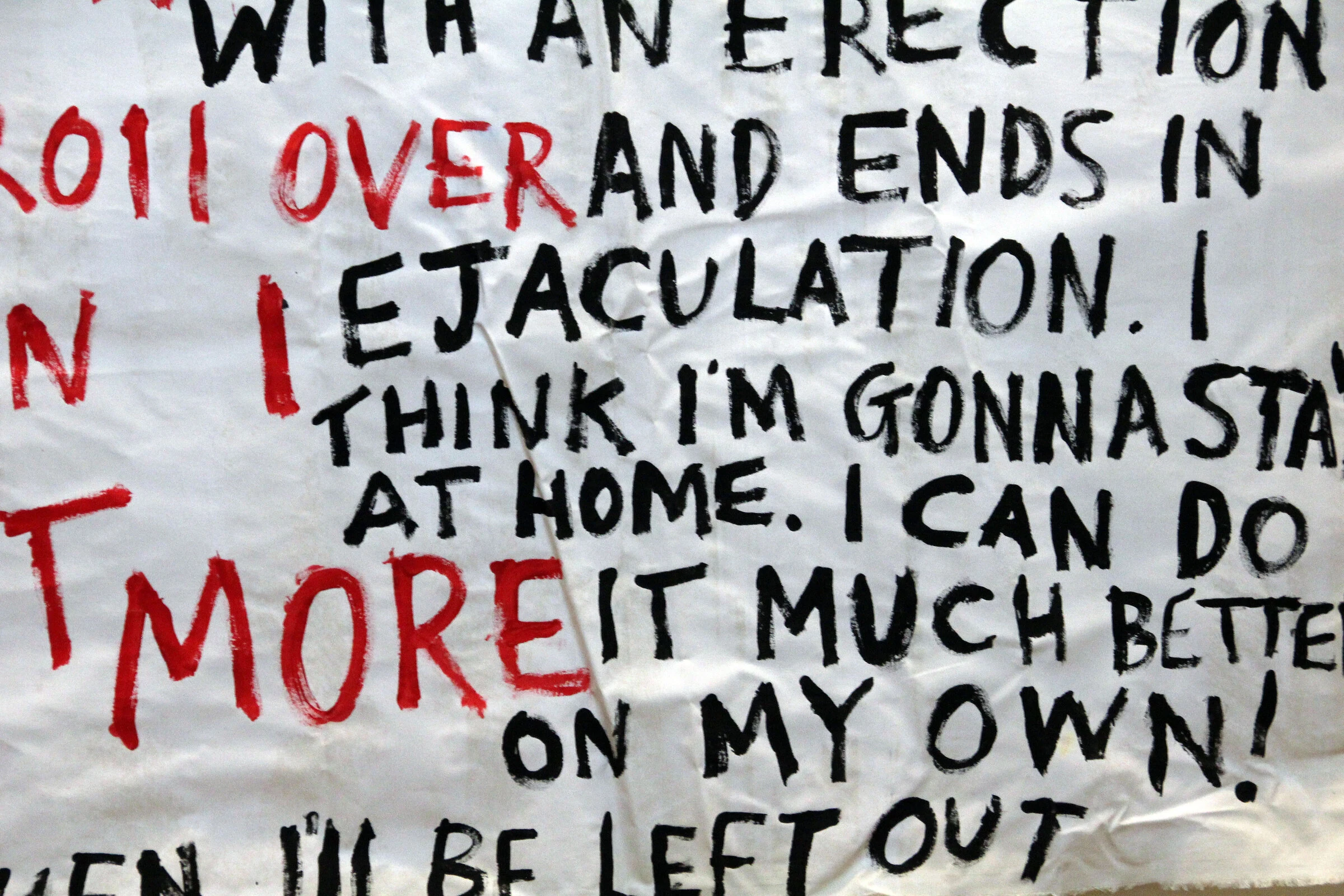 A close-up of red and black hand-painted lettering on the Lazy Lover backdrop.
