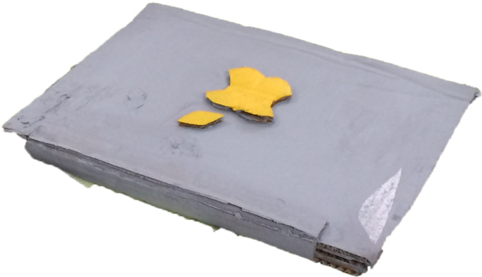 A handmade grey cardboard laptop with a yellow logo.