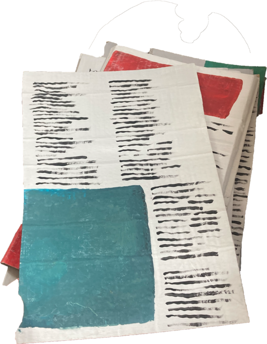 Handmade newspaper props with painted black lines and coloured blocks.