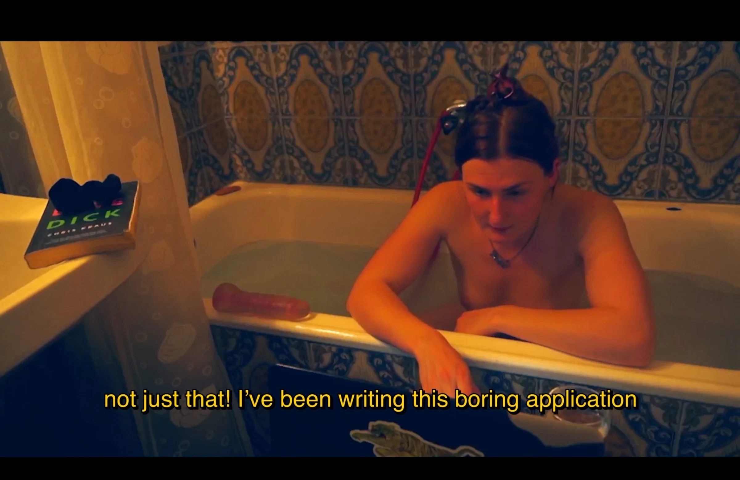 A character leaning over the edge of a bathtub in a patterned bathroom, with a subtitle about writing an application.