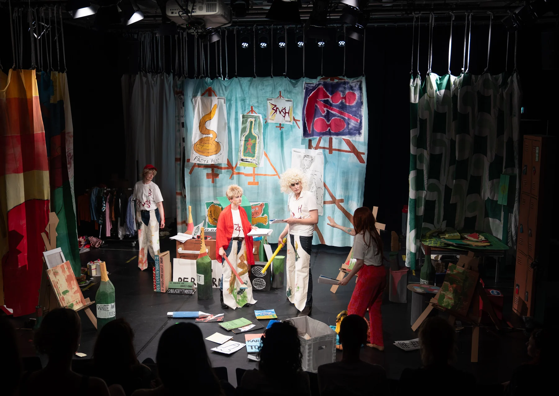 Painted stage backdrops surrounding performers in The Sound of Losers.
