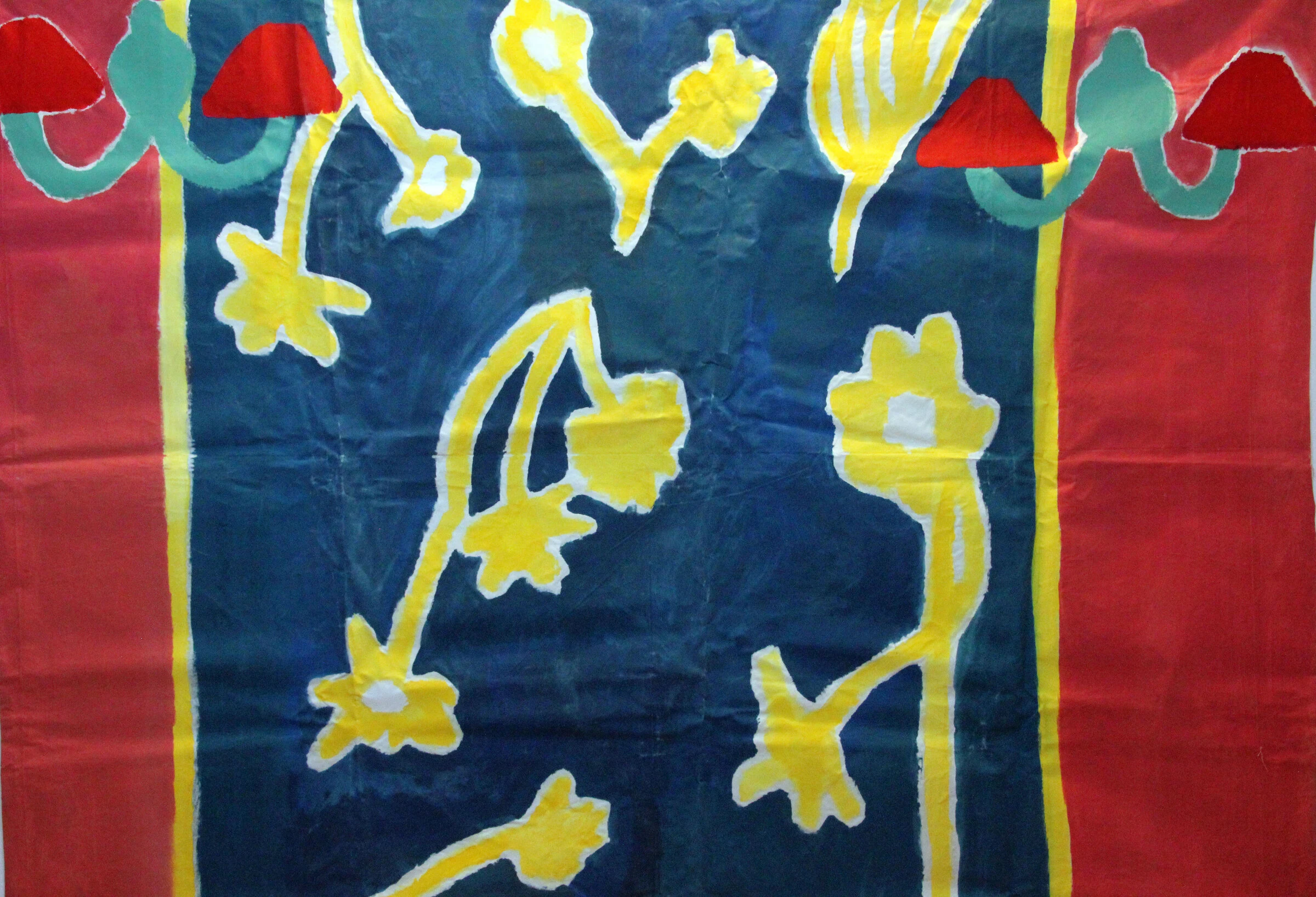A painted backdrop with yellow flower stems on dark blue, teal wall lamps and red side panels.