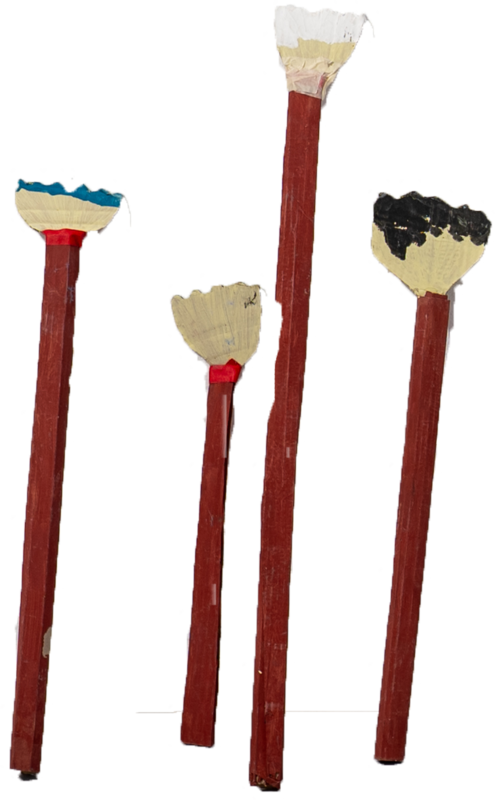 Four handmade paintbrush props with long red handles.